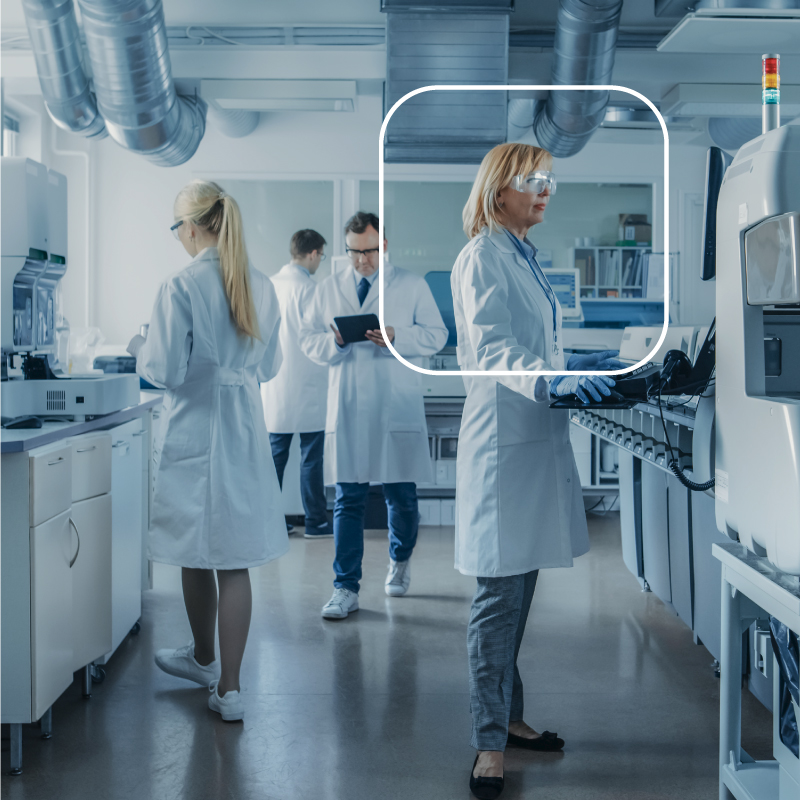 Scientist in front of lab equipment