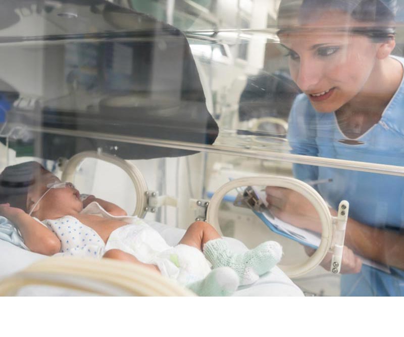 Nurse monitoring a new born who has receiving care using Covalon Technologies products